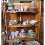 A pine side cabinet with raised back above open bookshelves, 127cm wide, 86cm high together with a