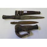 An ethnic dagger with leather handle and scabbard, blade 17cm long and a Mexican copper novelty