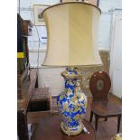 A large blue and yellow octagonal baluster form vase and cover, with allover foliate scroll and vase