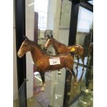 A Beswick figure of a horse, with cropped tail 19cm high, and another similar (2)