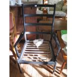 A vintage Parker Knoll ladderback Danish style armchair, frame finished black with fittings for