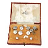 A boxed set of diamond set links and studs