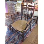 A William Morris style spindle turned armchair, circa 1900, with rush seat and turned legs joined by