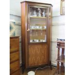 A 1960s rosewood corner display cabinet, the glazed door over an inlaid cupboard door, on moulded