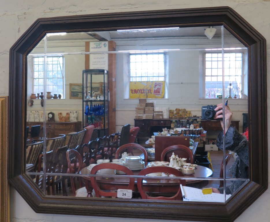 An oak framed octagonal wall mirror 53cm x 68cm