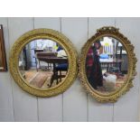 A circular giltwood framed mirror, 43cm diameter and an oval mirror