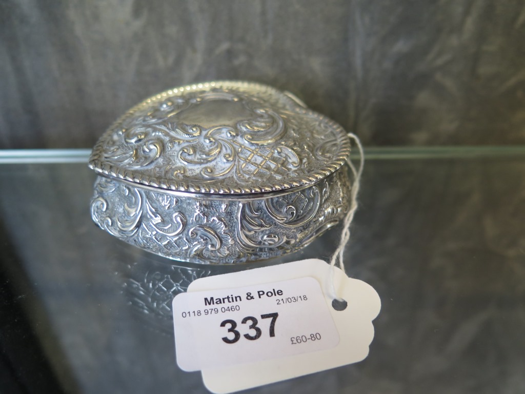 A heart shaped silver trinket box decorated in relief, Chester 1895