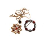 Two garnet brooches and a garnet pendant