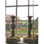A pair of Rococo revival ormolu candlesticks, late 19th century, of scroll and cartouche form with