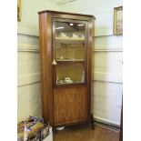 A 1960s rosewood corner display cabinet, the glazed door over an inlaid cupboard door, on moulded