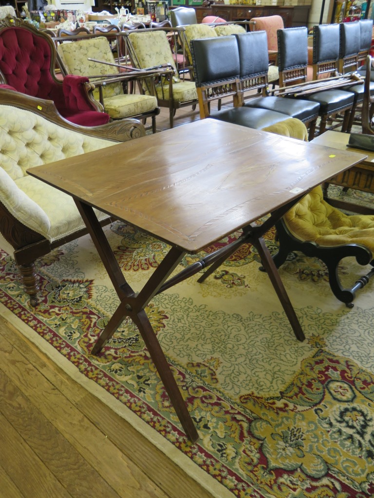 An Edwardian inlaid occasional table, the square chevron and diamond inlaid top on cross frame