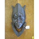 A well carved face mask, probably Baule Ivory Coast, Africa, 32cm long