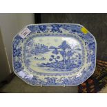 A Chinese blue and white dish, 18th century, depicting a lake scene with oarsmen and houses,