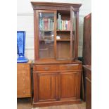 An Edwardian stained beech bookcase cabinet, the moulded cornice and scroll frieze over a pair of