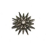 White metal and paste star form brooch