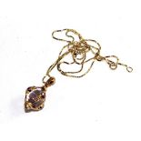 An amethyst pendant on gold neck chain