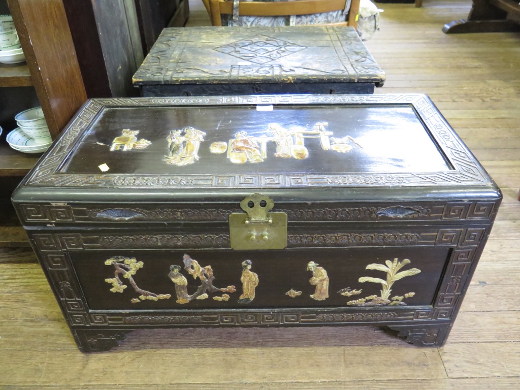 A stained camphorwood chest, with relief figural panels and bracket feet, 86cm wide 43cm deep,