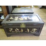 A stained camphorwood chest, with relief figural panels and bracket feet, 86cm wide 43cm deep,