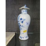 A Chinese blue and white baluster form vase and cover, depicting a bird on a branch, unmarked 22cm