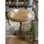 A Victorian walnut chess table, the circular inlaid top on a baluster turned stem, circular base and