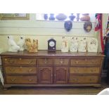 A George III oak and mahogany crossbanded dresser base, with two short central drawers above two