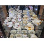 A Myott 'tete a tete' tea service, with painted yellow floral decoration, and a Carlton ware