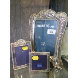 Two small silver photo frames, London 1977 and 1988, and a large silver plated photo frame with swag