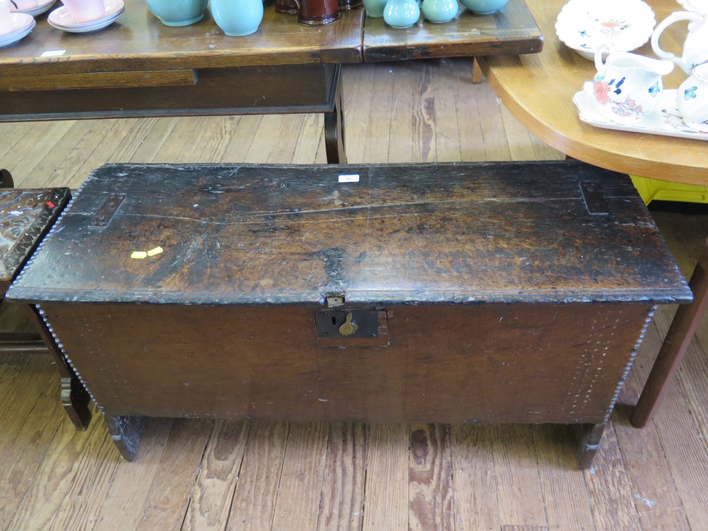 A 17th century oak planked chest with faceted corners and stampwork 102cm wide, 39cm deep, 54cm