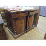 A pair of Victorian mahogany pedestals, converted from a sideboard, with tapering scroll carved