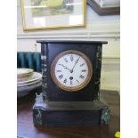 A black slate and green marble mantel timepiece, with enamel dial, 25cm high, a timber yoke and a
