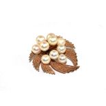 A 14 carat brooch/ pendant decorated with ten cultured pearls