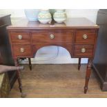 A Regency style mahogany and ebony lined kneehole desk, with false central drawer flanked by two