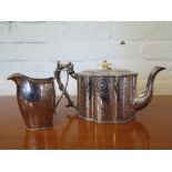 An early 19th century style helmet shaped silver plated milk jug and an Edwardian lobed tea pot (2)