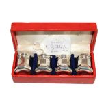 A cased set of four silver peppers by Cartier, 3.5cm high