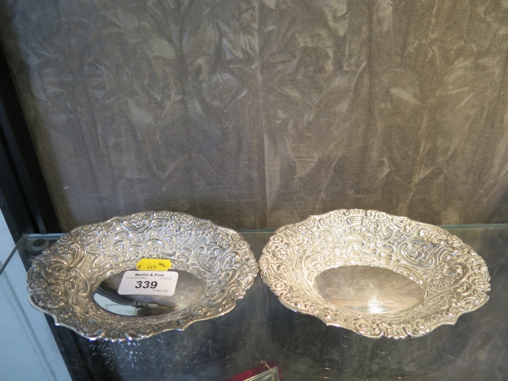 A pair of silver oval sweemeat dishes decorated in relief, Birmingham 1955