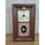 An American Jerome & Co thirty hour wall clock, in a mahogany case, with painted glass door