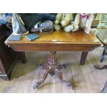 A mid Victorian mahogany foldover card table, the rectangular top enclosing a circular baize