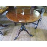 A George III mahogany snaptop tripod table, the circular top on a baluster stem and cabriole legs,