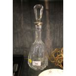 A continental metal collared cut glass decanter of facetted form 30.5cm high