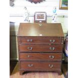A George III style mahogany bureau, the sloping fall enclosing a fitted interior over four long