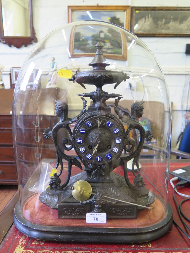 A late Victorian cast mantel clock, with blue enamel chapters, in a glass dome, dome 39cm high