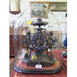 A late Victorian cast mantel clock, with blue enamel chapters, in a glass dome, dome 39cm high