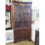 A mahogany reproduction concave corner display cabinet, the lancet arched glazed doors over cupboard