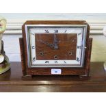 A 1930s oak mantel clock with square dial, the British Anvil three train movement striking on gongs,