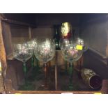 A set of six green stemmed wine glasses, another set of six amber stemmed wine glasses, a set of