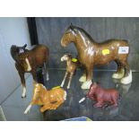 A Beswick figure of a shire horse, 21cm high, another of a horse looking to its left and three