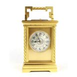 An Edwardian French gilt brass carriage clock with spiral twist columns and mother of pearl dial,