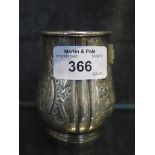 A silver beaker decorated in relief by Mappin & Webb