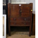 A Victorian pot cupboard with tray top and later protective glass, over twin cupboard doors and a