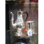 A silver plated coffee pot together with a collection of silver plate, including coaster and three